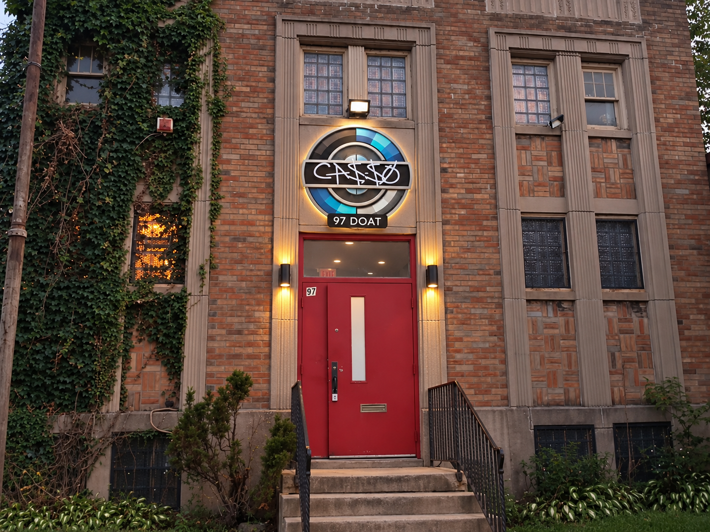 The Casso venue exterior at dusk with warm lights